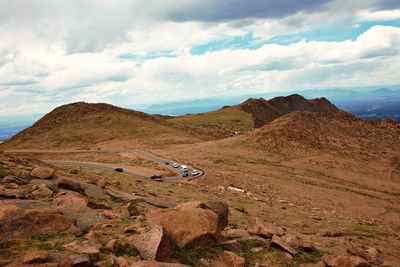 Scenic view of land and mountains against sky