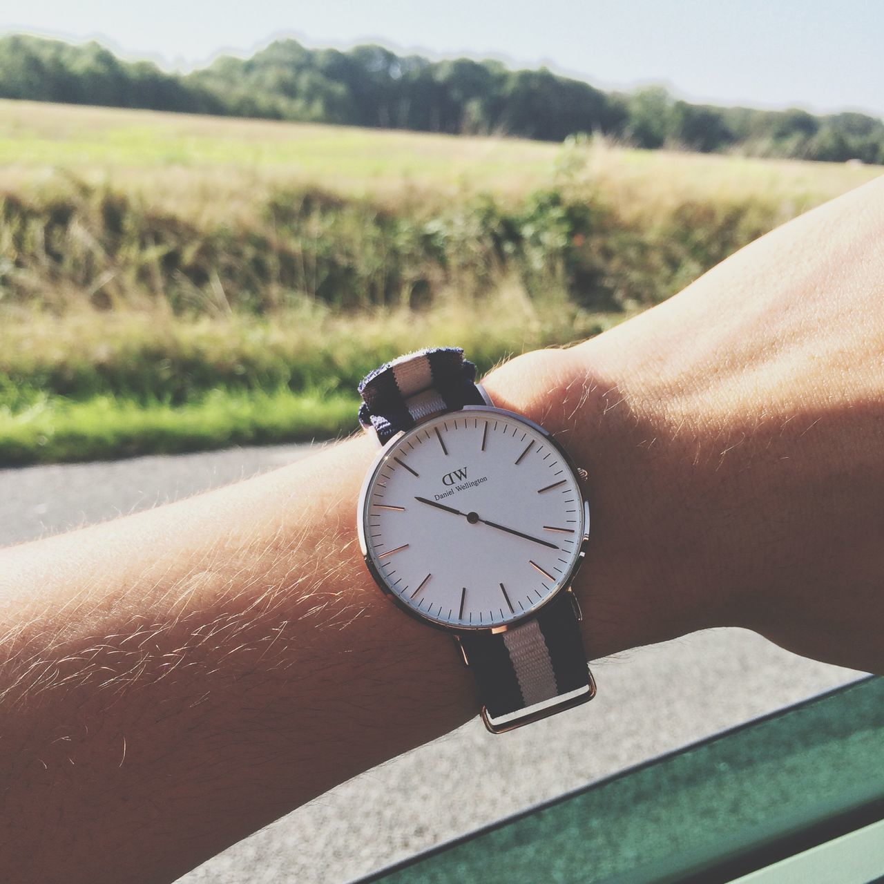 person, part of, time, cropped, focus on foreground, holding, landscape, close-up, wristwatch, personal perspective, field, outdoors, human finger, professional occupation, day, circle, hobbies