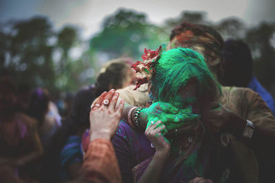 Close-up of hands holding multi colored people