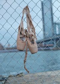 Close-up of chainlink fence hanging from wire