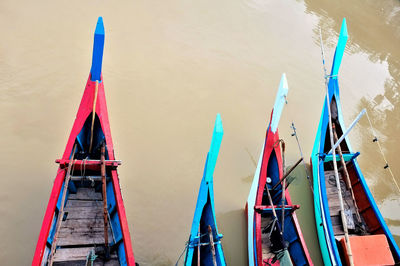 Cropped image of boats moored in river