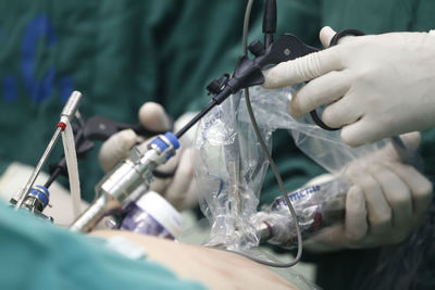 Midsection of surgeons operating patient