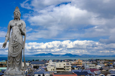 Low angle view of statue against cloudy sky
