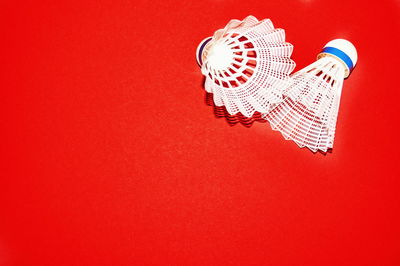 Close up of shuttlecock on red background