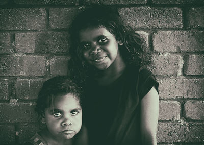 Portrait of smiling girl against wall