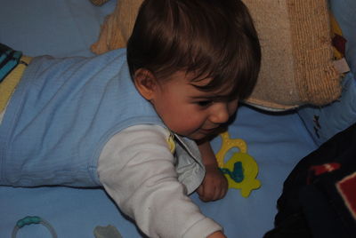 High angle view of cute boy holding toy at home