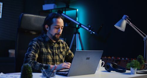 Midsection of woman using laptop on table