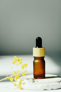 High angle view of woman holding bottle on table