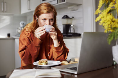 Woman using laptop at home