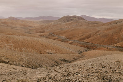 Scenic view of arid landscape against sky