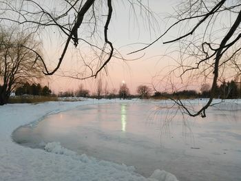 Scenic view of lake against sky during winter