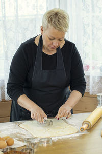 Full length of woman preparing food at home