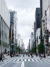 City street and buildings against sky