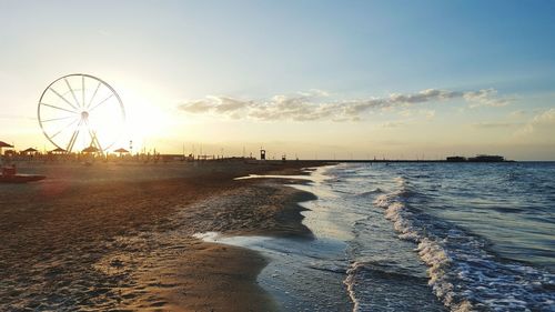 Scenic view of beach against sky during sunset