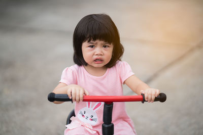 Portrait of cute girl riding bicycle