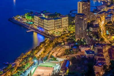 High angle view of illuminated buildings in city at night