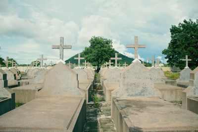 Cemetery against cloudy sky