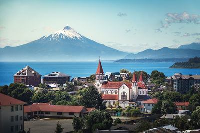 High angle view of townscape and mountains against sky