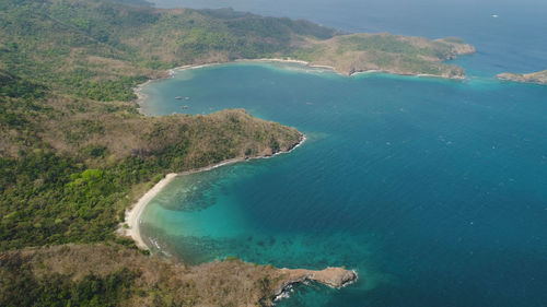 Aerial view of seashore with beach, lagoons and coral reefs. philippines, luzon. 