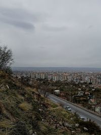 High angle view of road by buildings against sky