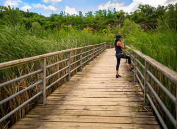 Full length of woman on footbridge