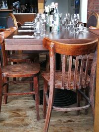 Empty chairs and tables at sidewalk cafe