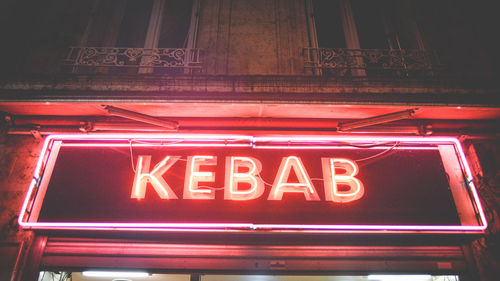 Low angle view of illuminated sign at night