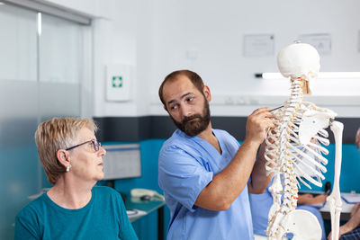 Doctor showing skeleton to patient