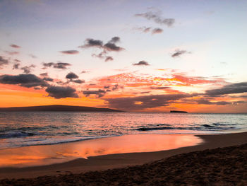 Scenic view of sea against romantic sky at sunset