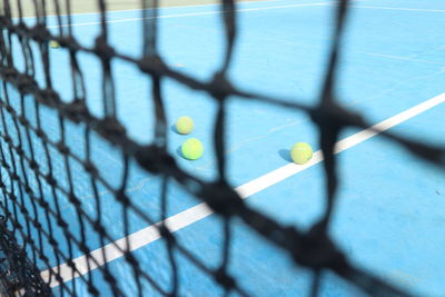 High angle view of yellow ball on fence