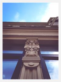 Low angle view of building against cloudy sky