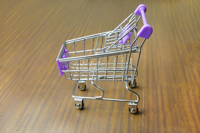 High angle view of empty shopping cart on wooden table