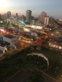 High angle view of illuminated cityscape against sky at night