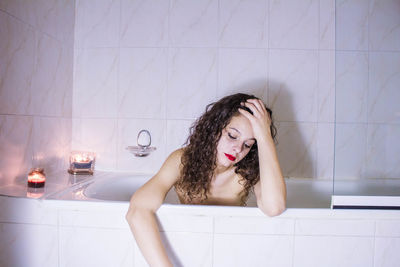 Portrait of young woman in bathroom