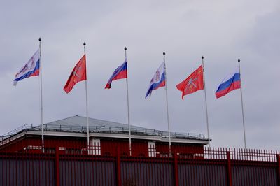 Low angle view of flag flags against sky