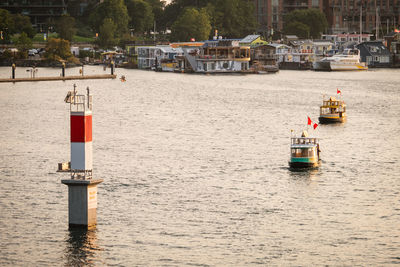 Sailboat moored on river in city