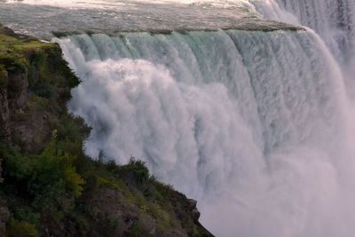 Scenic view of waterfall against sky