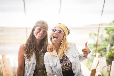 Mid adult hipster women dancing on field