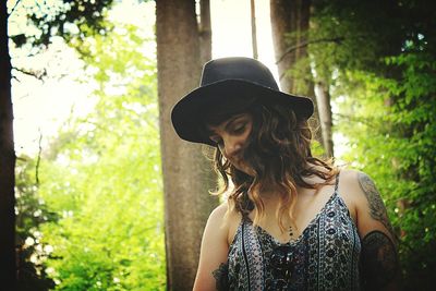 Beautiful young in hat looking down