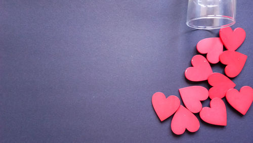 High angle view of heart shape on pink table