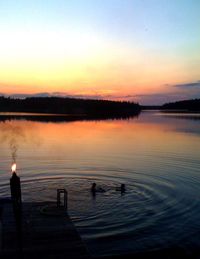 Scenic view of lake at sunset