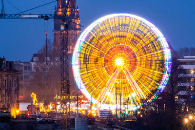 Illuminated ferris wheel at night