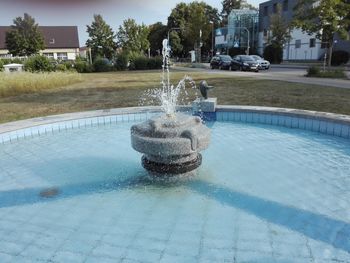 Water fountain in swimming pool in yard