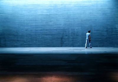 Full length side view of a man walking in city