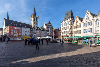 People on street by buildings in town