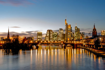 Illuminated buildings in city at waterfront