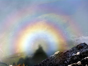 Rainbow over mountain against sky