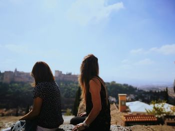 Friends sitting against palace