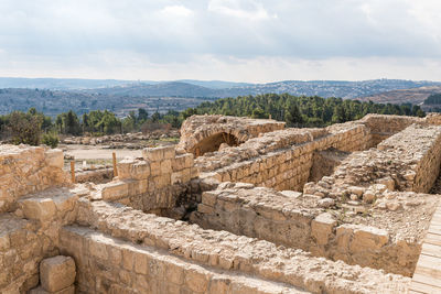 Old ruins in city against sky