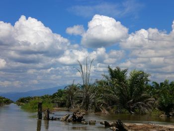 Scenic view of lake against cloudy sky